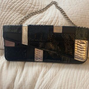 NEW without tags BEBE silver and black snake embossed clutch with should strap